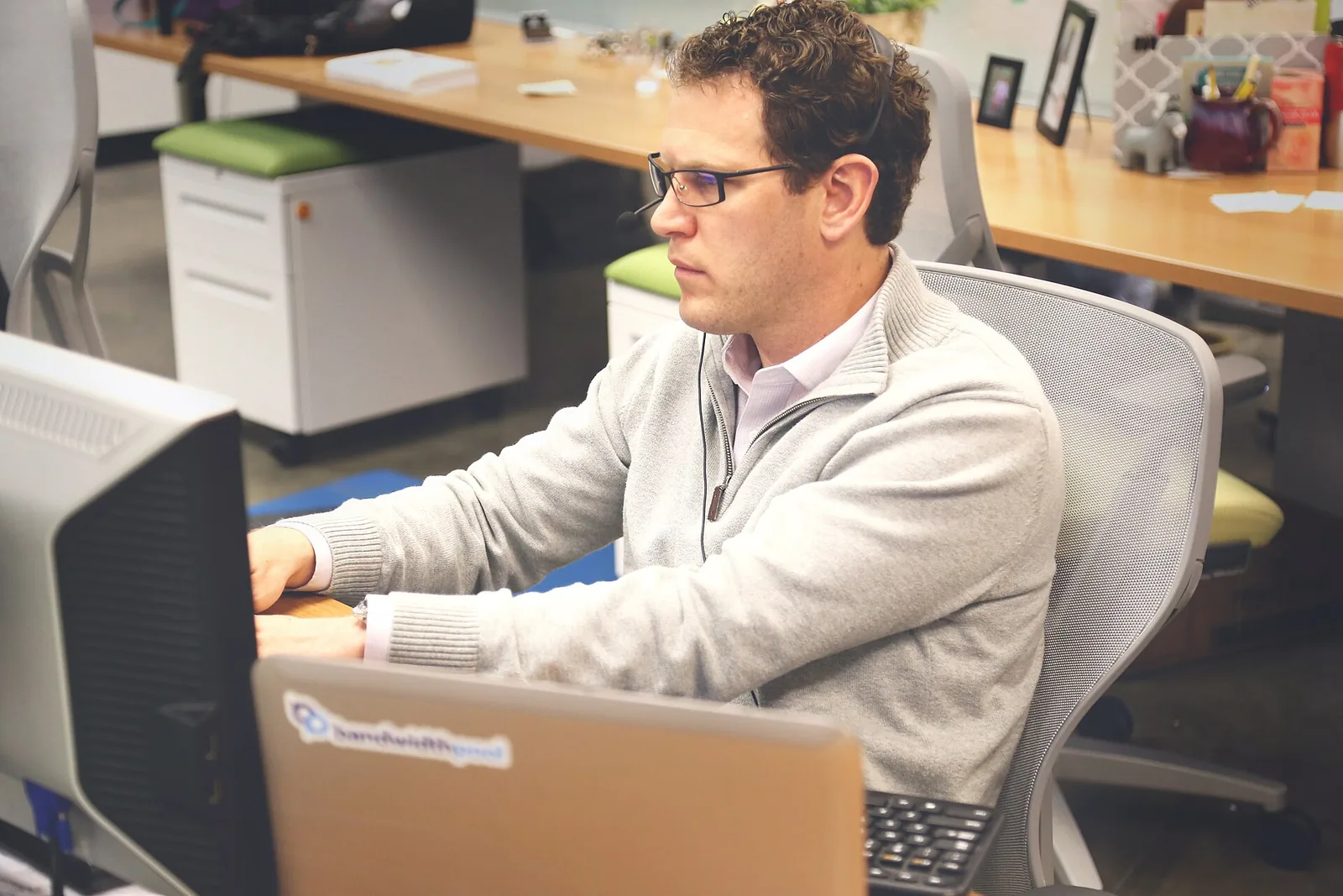 A man working at a computer at an office desk
